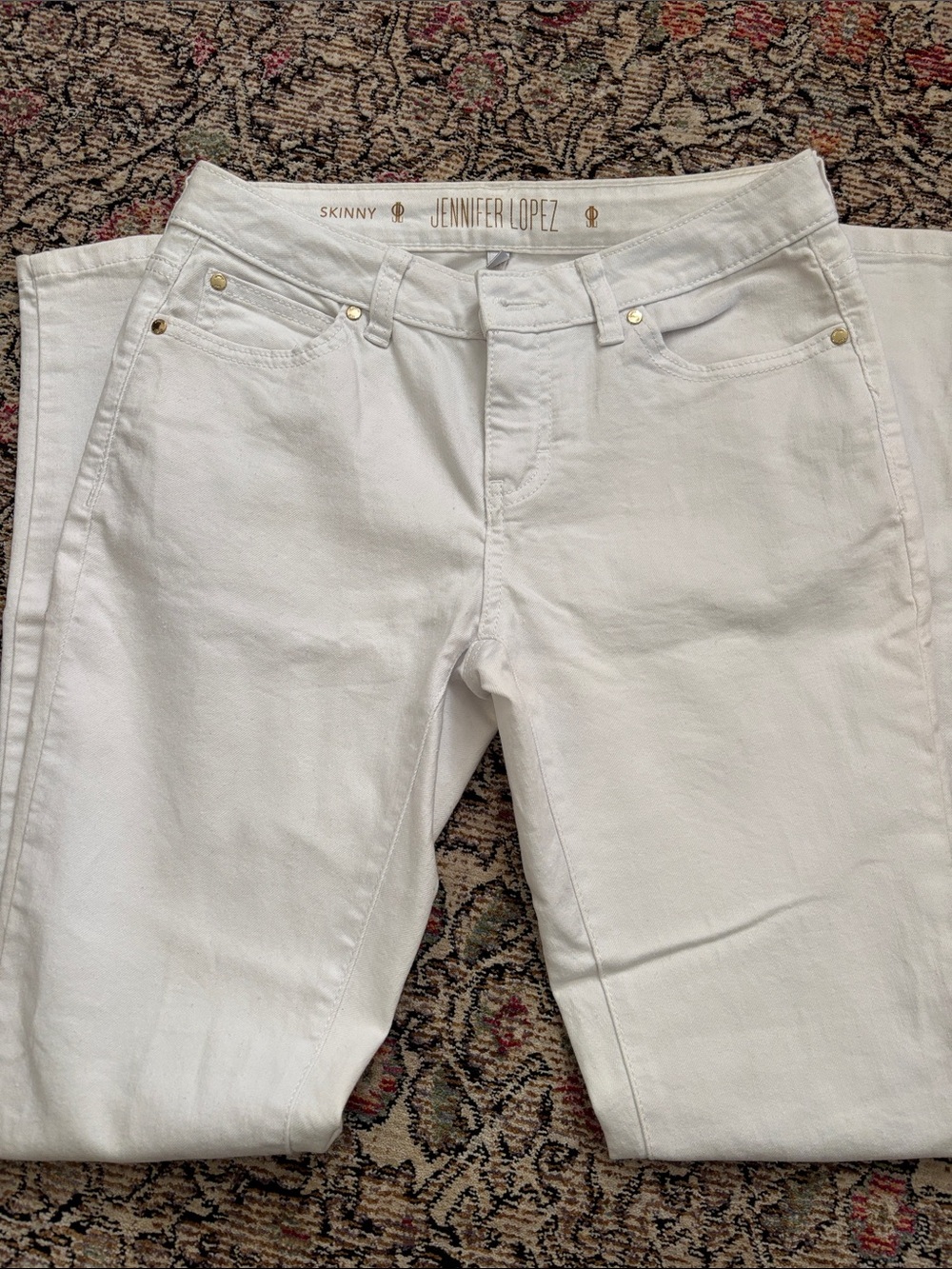 Jennifer Lopez Crisp White Skinny Jeans with Gold Accents